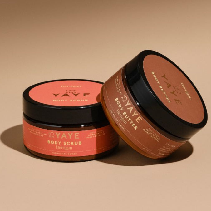 Sweet Berrigan Body Scrub and Body Butter from Yaye’s Glow Bundle, with one jar gently leaning against the other, styled to highlight the rich caramel-vanilla tones and native Emu Bush extract.

