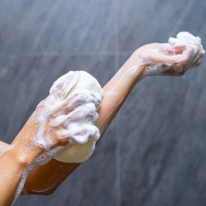 Hand with soap in shower