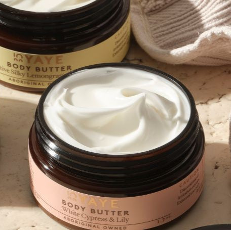 YAVE body butter jars with white cream on a beige background