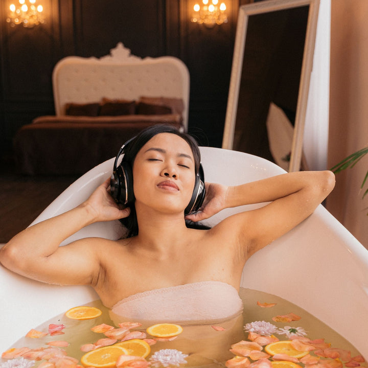 Bath scene with headphones and Yaye body scrub – Aboriginal audio for bath rituals and immersive relaxation