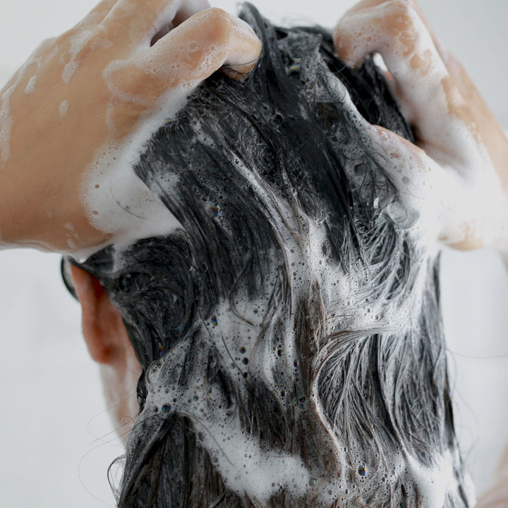 Woman washing hair with Yaye Native Silky Lemongrass & Lime Shampoo – natural Aboriginal haircare for clean, strong, and healthy hair